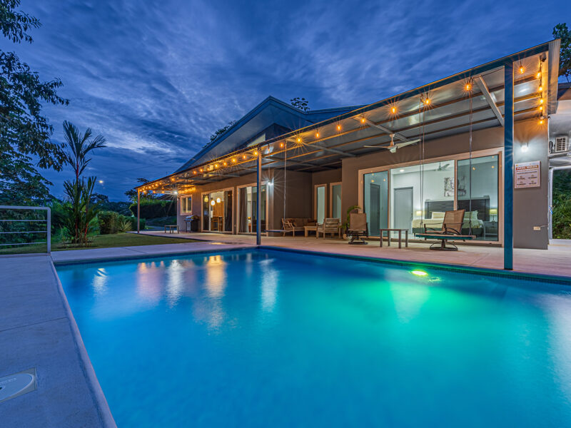 Residencia moderna de una planta con piscina privada, jardines tropicales y quebrada en Uvita.